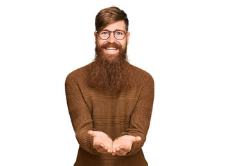 Canvas Print - Young irish redhead man wearing casual clothes and glasses smiling with hands palms together receiving or giving gesture. hold and protection