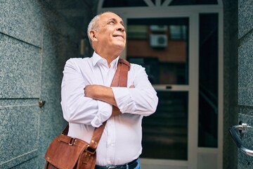 Wall Mural - senior businessman smiling happy walking at the city.