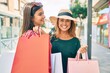 © Krakenimages.com - Beautiful hispanic mother and daughter smiling happy and shopping at the city.