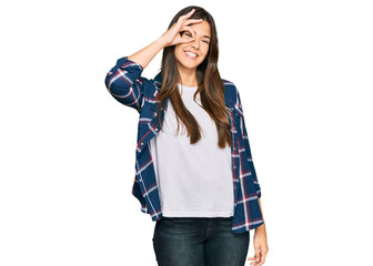 Sticker - Young brunette woman wearing casual clothes smiling happy doing ok sign with hand on eye looking through fingers