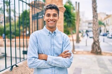 Canvas Print - Young latin man smiling happy walking at the city.