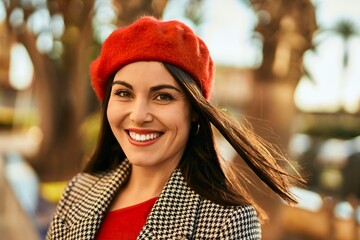 Young hispanic woman smiling happy standing at the city.