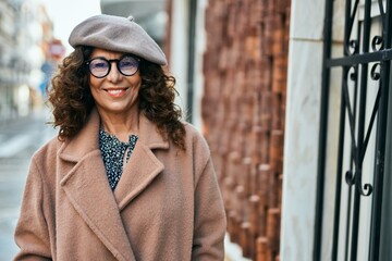 Sticker - Middle age hispanic woman smiling happy standing at the city.