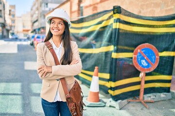 Sticker - Young latin architect girl smiling happy standing at the city.