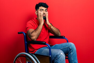 Sticker - Arab man with beard sitting on wheelchair tired hands covering face, depression and sadness, upset and irritated for problem