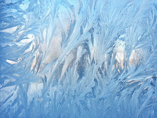 frosty patterns on the window glass closeup. natural textures and backgrounds. ice patterns on frozen