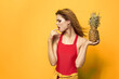 © SHOTPRIME STUDIO - woman with pineapple in hands white t-shirt Exotic summer fun yellow background