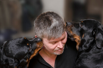 emotional portrait of a man with two pets on a blurred backgroun