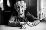 Fototapeta  - Portrait of an old woman pensioner in her house. Black and white photo.
