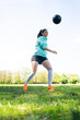 © Mego-studio - Young woman practicing soccer skills with ball.