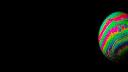 Wall Mural - Bubble macro. Abstract galaxy background with globe planet earth in universe space with sunlight on dark background. Macro soap bubble made with dish soap.