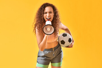 Poster - Beautiful young woman with megaphone and soccer ball on color background