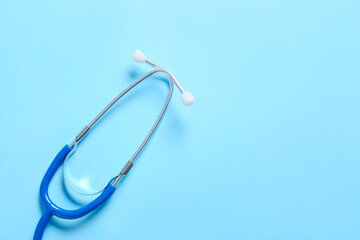 Modern stethoscope on color background