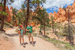 © Maridav - People hiking - couple hikers in Bryce Canyon walking on trail happy with backpacks. Multiracial young Asian woman and Caucasian man in Bryce Canyon National Park landscape, Utah, United States.