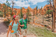 © Maridav - Hiking couple hikers walking smiling happy in summer mountain nature. Interracial couple Asian woman and Caucasian man in Bryce Canyon National Park landscape, Utah, United States.