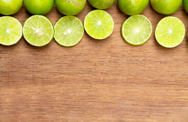 top view of a nice brown rustic wooden table with sliced lemon and lemon fruits on top with copy space and for background