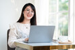 © Thinapob - Happy of asian freelance people Businesswoman wearing wireless earphones casual working with laptop computer with a coffee cup mug,Notebook and smartphone at the cafe,Business Lifestyle communication