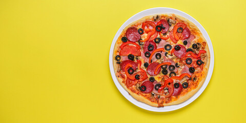 Wall Mural - A whole, cooked and sliced peperoni pizza on a colorful backgroud, various colors. Copy space banner.