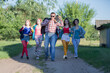 © Светлана Лазаренко - A funny guy with a cassette tape recorder and a group of beautiful girls are walking along the road.