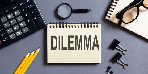 Poster - Notepad with inscriptions DILEMMA on a grey background with office tools . business concept.