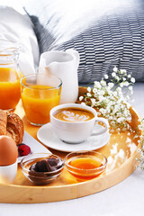 Wall Mural - A tray with breakfast on a bed in a hotel room