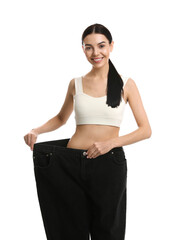 Poster - Happy young woman wearing big jeans after weight loss on white background