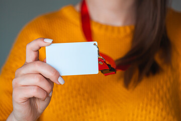 Woman holding badge name tag, with blank space mock up