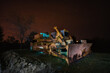 Bulldozer in a field in the nighttime