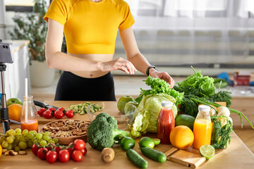 Cropped redhead food blogger working on new video, explaining how to cook dish, recording video