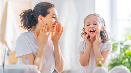 Wall Mural - Mother and daughter caring for skin