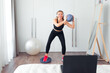 © shapovalphoto - woman doing fitness exercise at home using ball