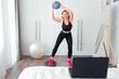 © shapovalphoto - woman doing fitness exercise at home using ball
