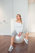 © shapovalphoto - woman sit on fitness ball at home, pilates exercise