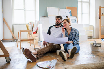 mid adults couple planning indoors at home, relocation and diy concept.
