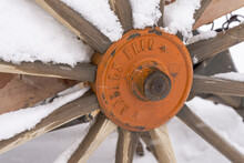 Wheel Of Sowing Machine In The Snow Of Spring.