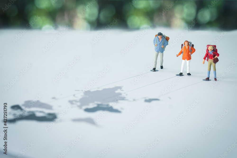 Miniature people backpacker standing on world map with line to ...