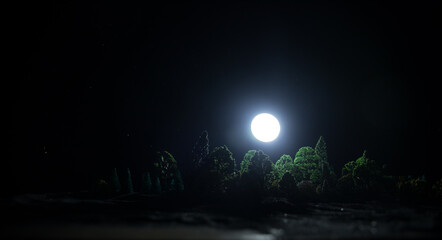 Wall Mural - Mountain Road through the forest on a full moon night. Scenic night landscape of country road at night with large moon