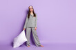 Full length body size view of attractive cheerful girl wear pajama carrying soft pillow bedtime isolated on violet purple color background
