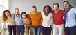 © Studio Romantic - Team of happy diverse business colleagues and friends having fun together. Group portrait of excited people standing in row, huddling, laughing and looking at camera. Support and union concept, banner