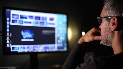 Man With Glasses Working on Computer Or Tablet