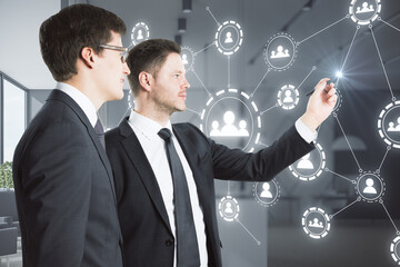 Aufkleber - Two businessmen touching the multiple application hologram icons with coworking space in the background. Social media and communication concept