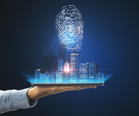 Poster - Hand with a tablet holding a city view hologram on a blue background. Internatonal business and market concept