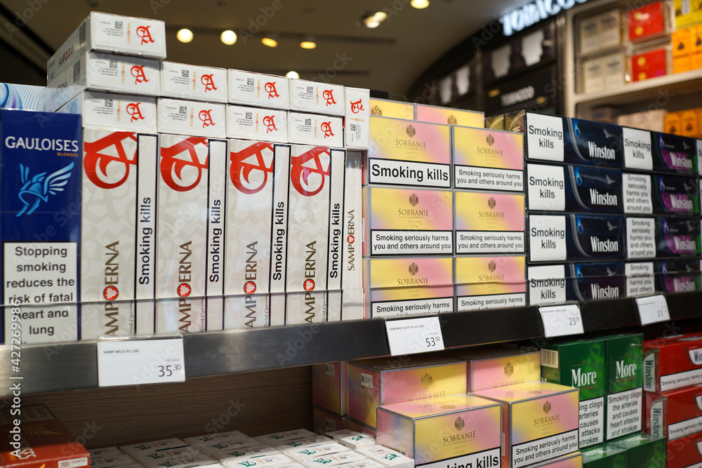 cigarettes airport prices Various brands of tobacco on store shelf in Changi Airport Terminal 2.  Tobacco use is a