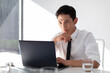 © Blue Jean Images - Young businessman working in office