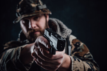 Wall Mural - Armed with modern handgun guy in camouflage equipment