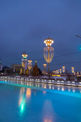 Wall Mural - New Year’s night skating rink at VDNH, Moscow, Russia. Christmas illumination and lights reflected on ice.