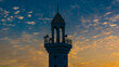 minaret of mosque with blue yellow  cloudy sunset
