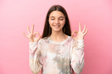 Little girl over isolated pink background in zen pose