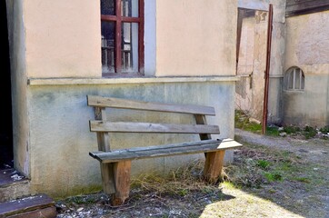 A mystical old wooden bench in an abandoned place. An unusual bench in an ordinary place. An old wooden bench.