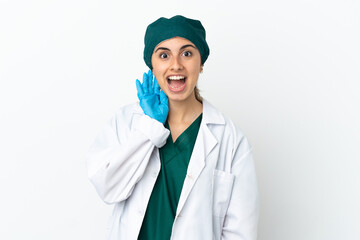 Surgeon caucasian woman isolated on white background with surprise and shocked facial expression